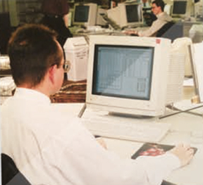 A designer at an early desktop publishing workstation