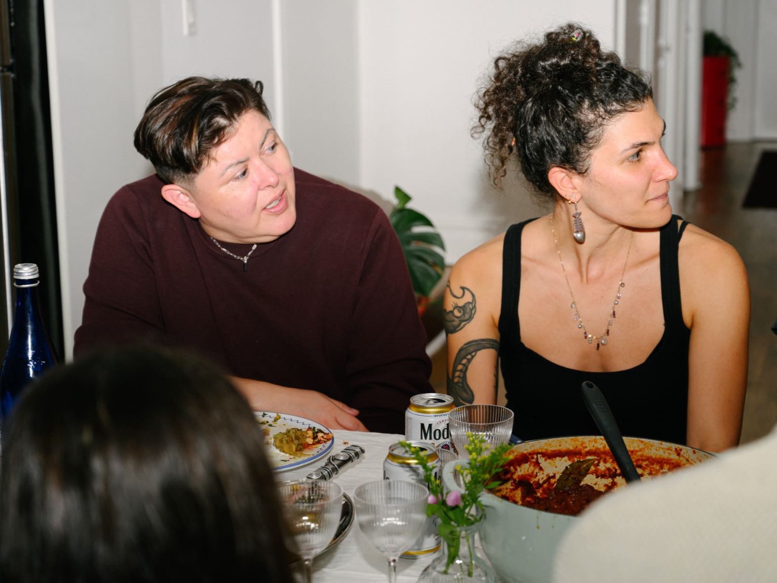 Two guests mid-conversation at the dinner table